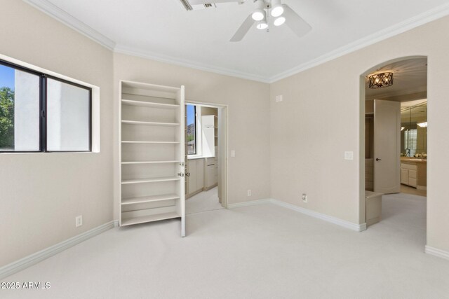 6467 E Sierra Vista Dr, Paradise Valley, AZ 85253 - unfurnished bedroom with crown molding, baseboards, ceiling fan, arched walkways, and carpet