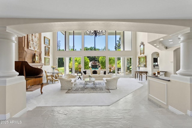 6467 E Sierra Vista Dr, Paradise Valley, AZ 85253 - living area featuring marble finish floor, decorative columns, and a towering ceiling