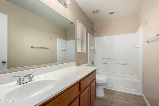 full bath with shower / washtub combination, visible vents, toilet, vanity, and wood finished floors