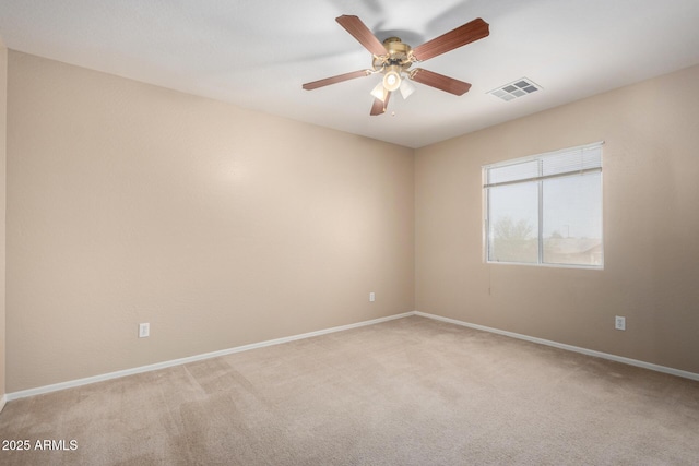 empty room featuring baseboards, a ceiling fan, visible vents, and light colored carpet