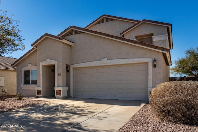 view of front of house featuring a garage, concrete driveway, a tiled roof, and stucco siding