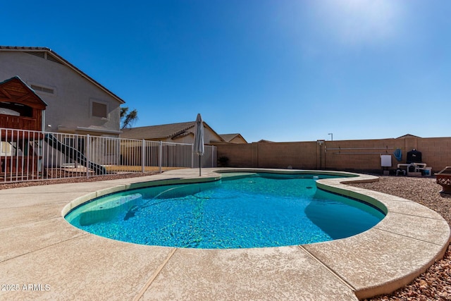 view of swimming pool featuring a patio, a fenced backyard, and a fenced in pool