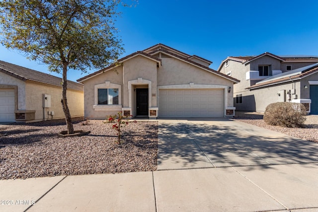 view of front of home featuring driveway, an attached garage, and stucco siding