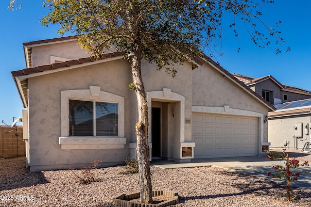 view of front facade with driveway, an attached garage, and stucco siding