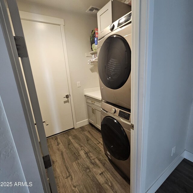552 Allerton Way, Chino Valley, AZ 86323 - washroom with cabinet space, stacked washing machine and dryer, and dark wood-type flooring