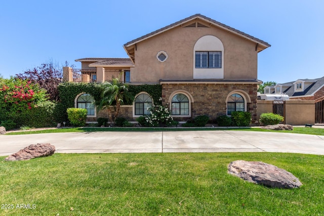 3203 E Ellis St, Mesa, AZ 85213 - mediterranean / spanish house featuring a front lawn, stone siding, and stucco siding