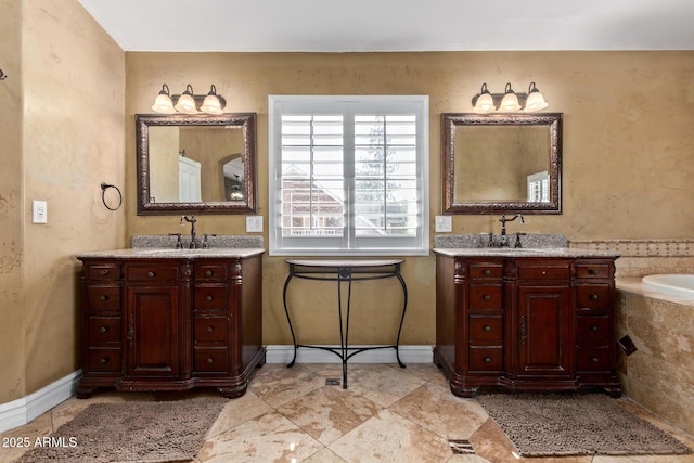 3203 E Ellis St, Mesa, AZ 85213 - full bath featuring baseboards, a sink, tiled tub, and two vanities
