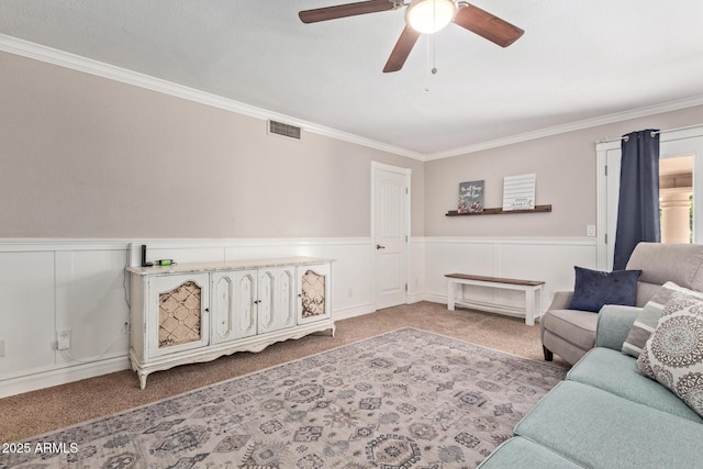 3203 E Ellis St, Mesa, AZ 85213 - living room featuring visible vents, crown molding, a wainscoted wall, and carpet floors