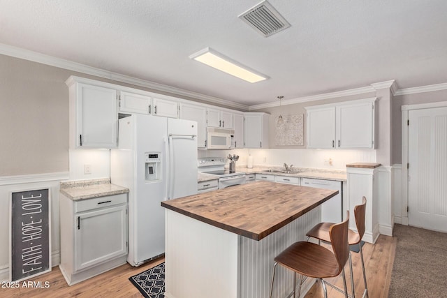 3203 E Ellis St, Mesa, AZ 85213 - kitchen with visible vents, ornamental molding, wooden counters, white appliances, and white cabinetry