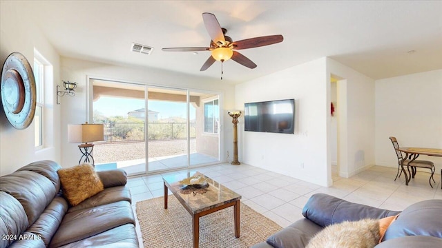 tiled living room featuring ceiling fan and a healthy amount of sunlight