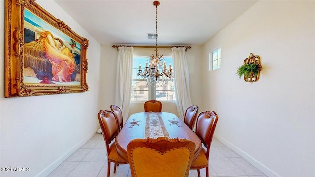 dining room with light tile patterned floors and an inviting chandelier