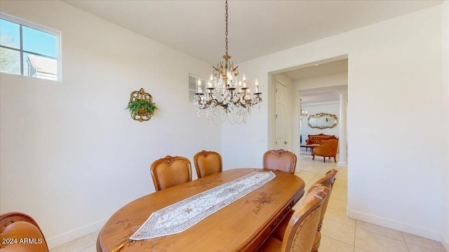 tiled dining room with a chandelier