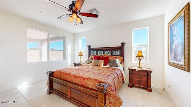 bedroom with ceiling fan and light tile patterned floors