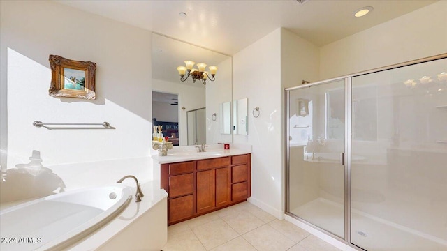 bathroom featuring tile patterned floors, vanity, independent shower and bath, and a chandelier