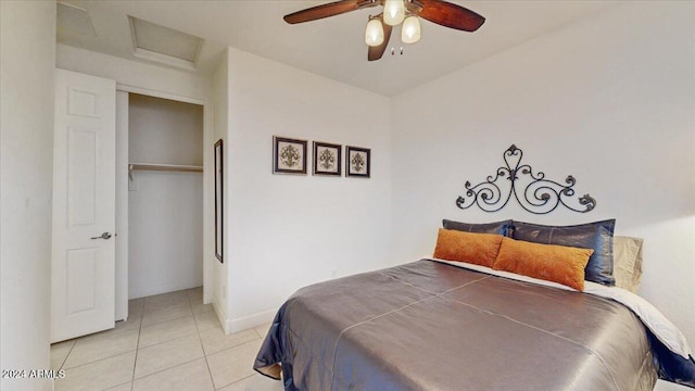 tiled bedroom with ceiling fan and a closet