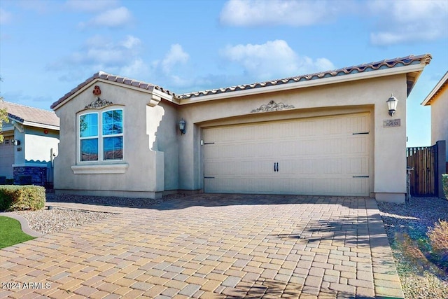 mediterranean / spanish home with a garage