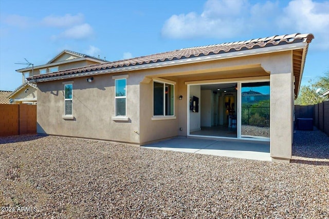 rear view of property featuring cooling unit and a patio area