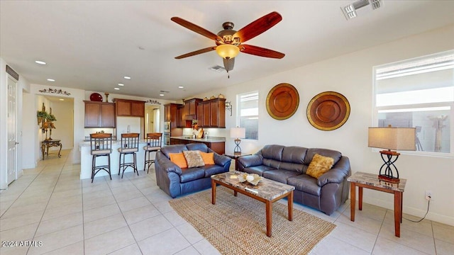 living room with ceiling fan and light tile patterned floors