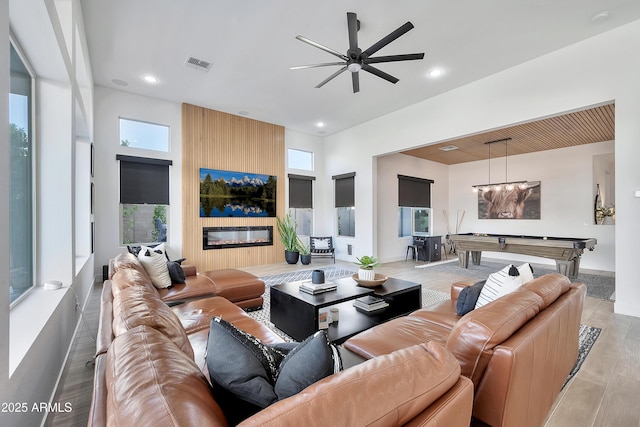 living area featuring recessed lighting, a large fireplace, pool table, wood finished floors, and visible vents