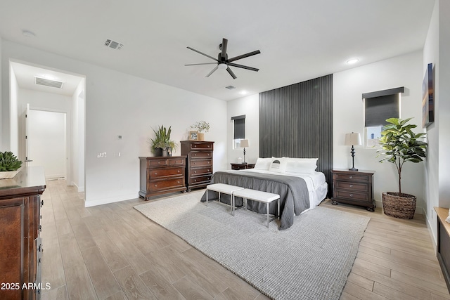 bedroom with light wood finished floors, visible vents, and recessed lighting