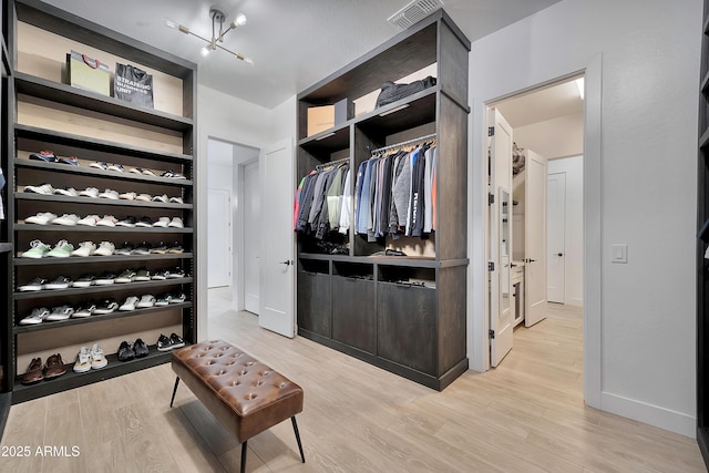 spacious closet featuring light wood-style flooring and visible vents