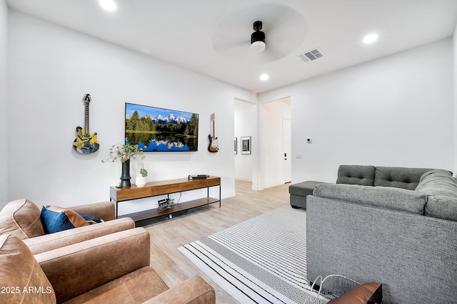 living area with light wood-style floors, ceiling fan, visible vents, and recessed lighting