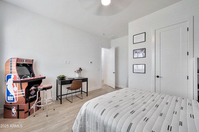 bedroom with visible vents, ceiling fan, baseboards, and wood finished floors