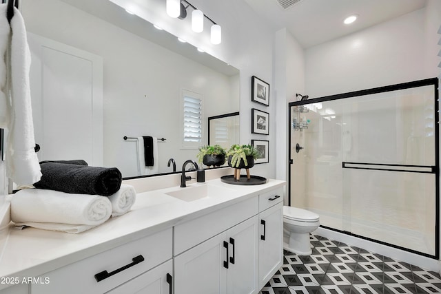 full bath with vanity, a shower stall, toilet, and recessed lighting