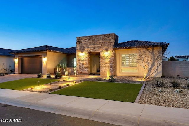 view of front of house featuring stone siding, stucco siding, and a tiled roof