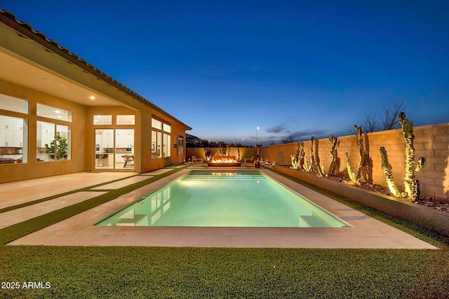 view of swimming pool with a fenced in pool, a fenced backyard, and a patio