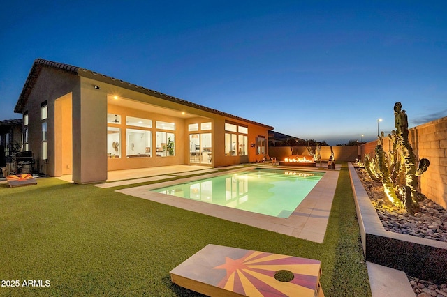 view of pool with a fenced backyard, a fenced in pool, a lawn, and a patio