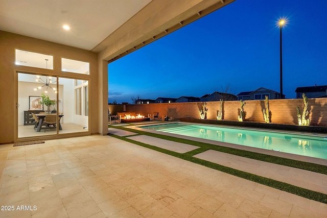 view of pool featuring a fenced backyard, a fenced in pool, and a patio