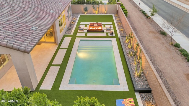 view of swimming pool featuring a patio and a fenced backyard