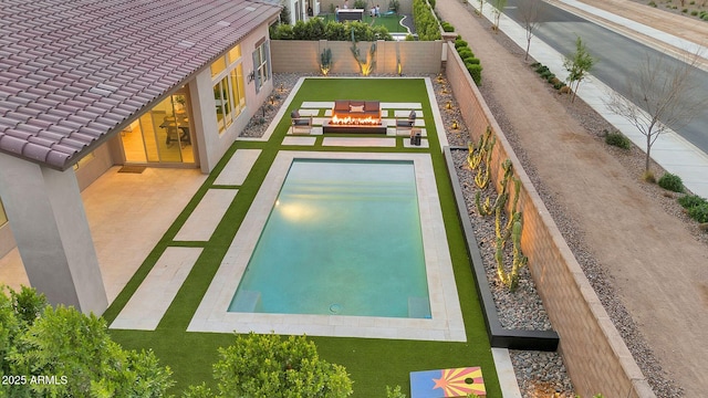 view of pool featuring a fenced backyard and a patio