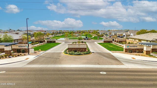 view of property's community featuring driveway and a residential view