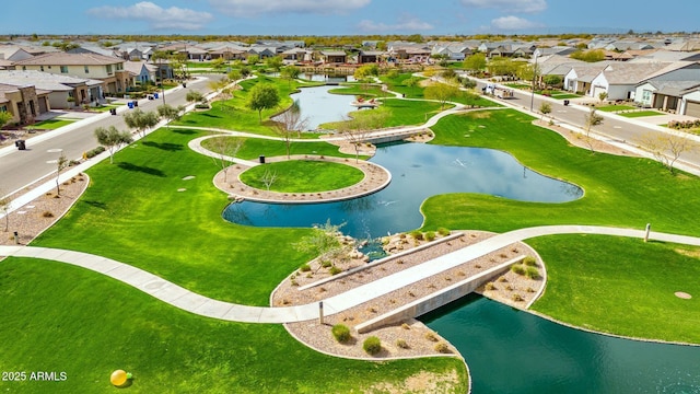 drone / aerial view featuring a water view and a residential view