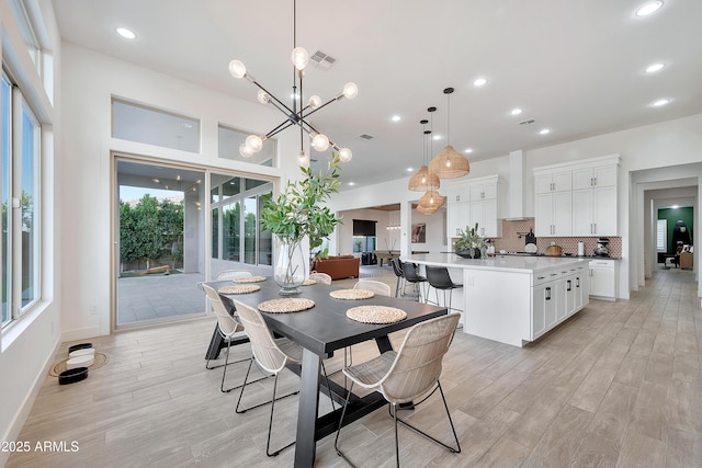 dining space featuring light wood-type flooring, visible vents, and recessed lighting