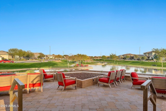 view of patio with a water view