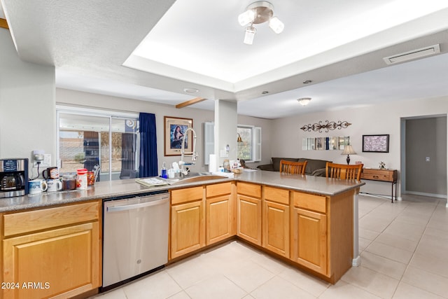 kitchen with dishwasher, kitchen peninsula, sink, light tile patterned flooring, and a textured ceiling