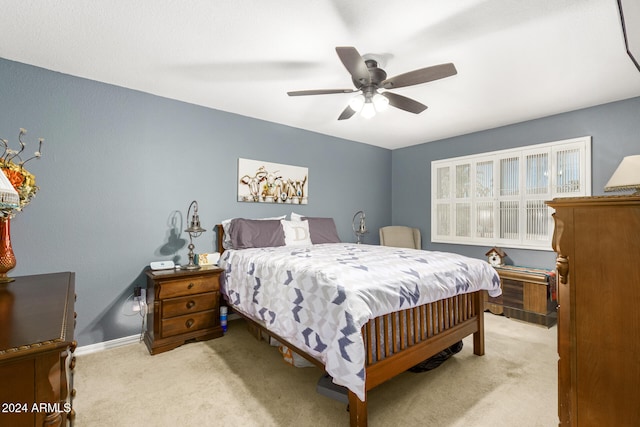 bedroom featuring light carpet and ceiling fan