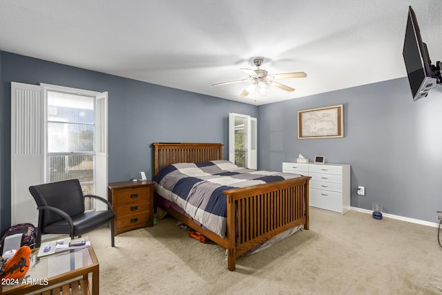 bedroom with ceiling fan and light colored carpet