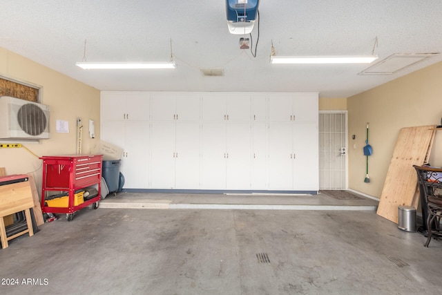 garage featuring ac unit and a garage door opener