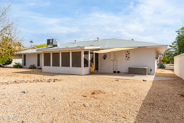 back of property with central AC, a patio area, and a sunroom