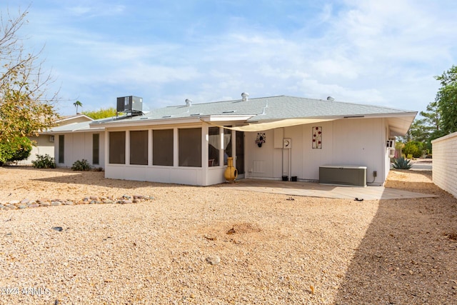 back of property featuring central AC unit, a patio area, and a sunroom