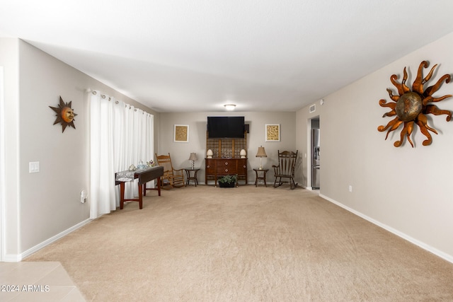 living area featuring light carpet