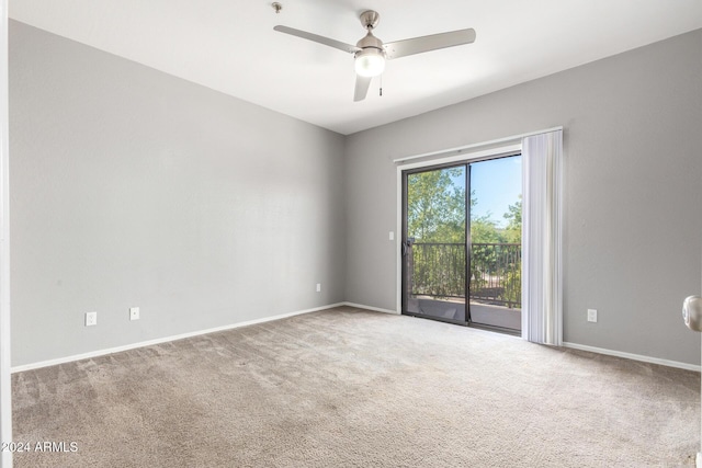 carpeted spare room featuring ceiling fan