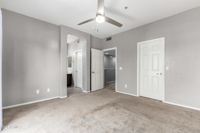 unfurnished bedroom featuring connected bathroom, ceiling fan, and carpet floors