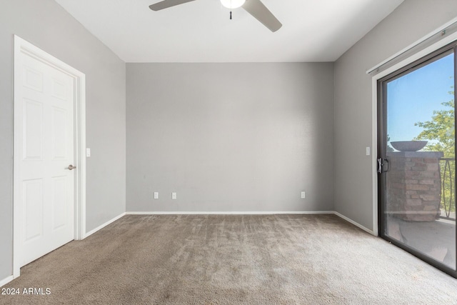 carpeted empty room featuring ceiling fan