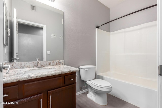 full bathroom with washtub / shower combination, tile patterned flooring, vanity, and toilet