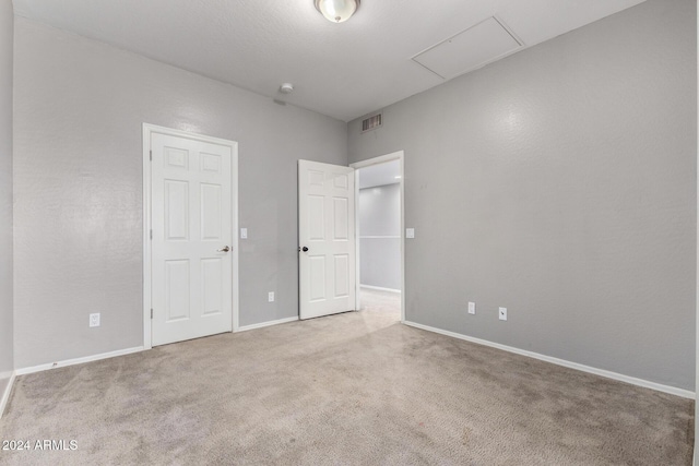 unfurnished bedroom featuring light colored carpet